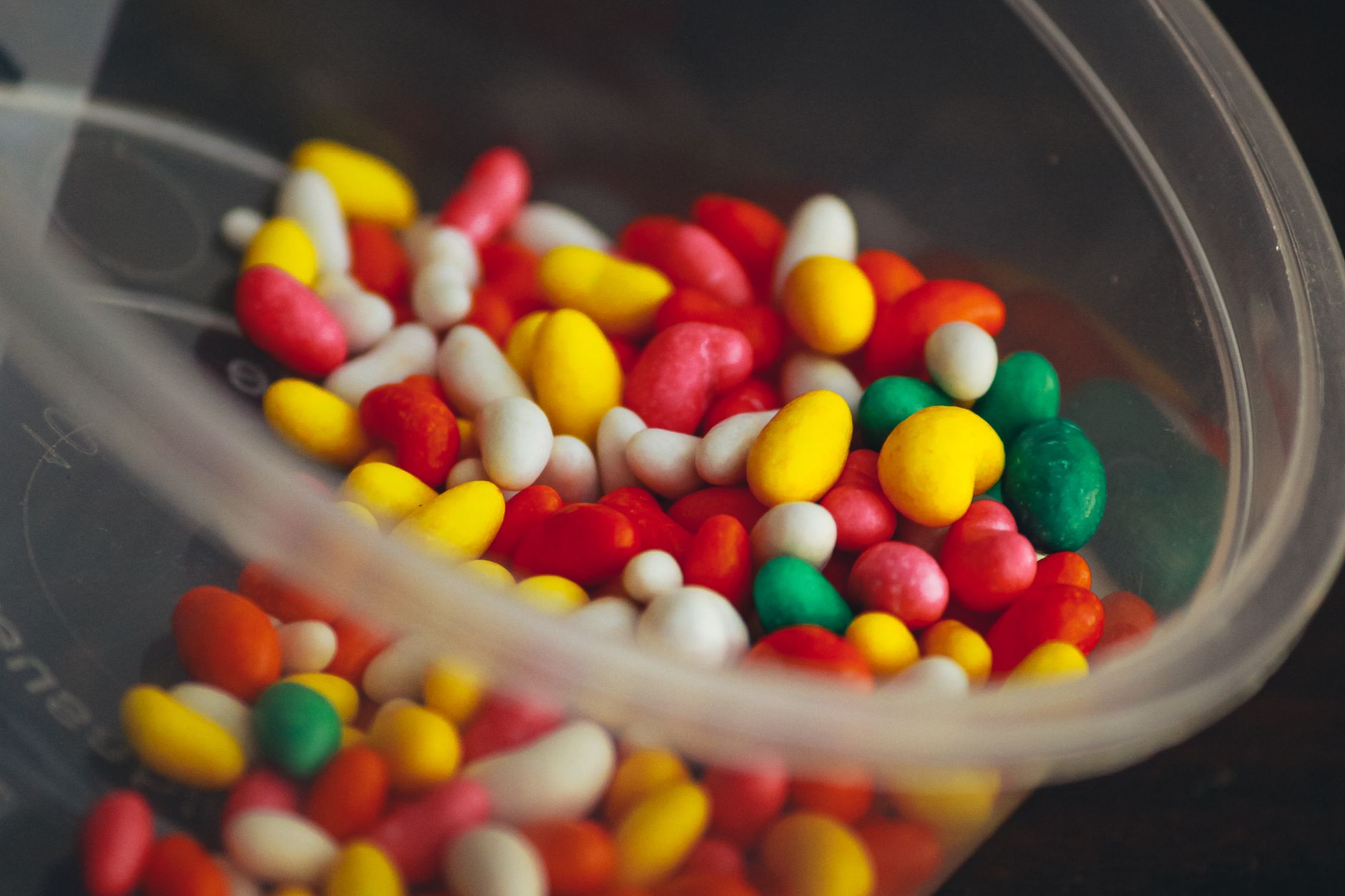Close-up of colorful old-fashioned candy pieces arranged in jars on a pantry shelf