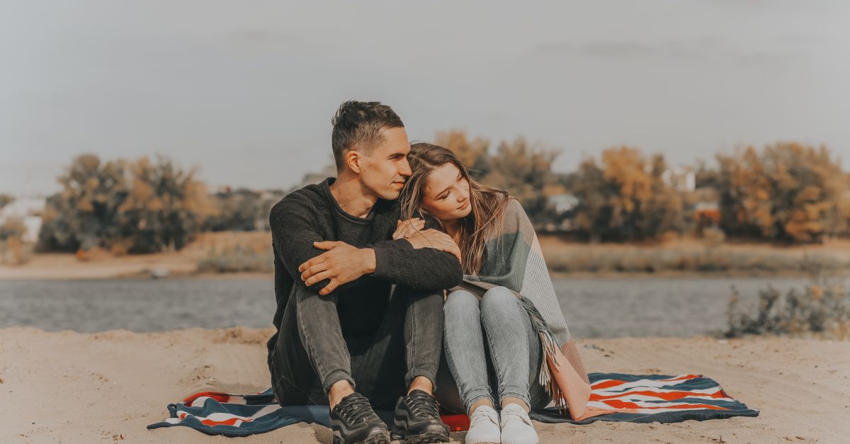 Romantic couple sitting on riverside · Free Stock Photo