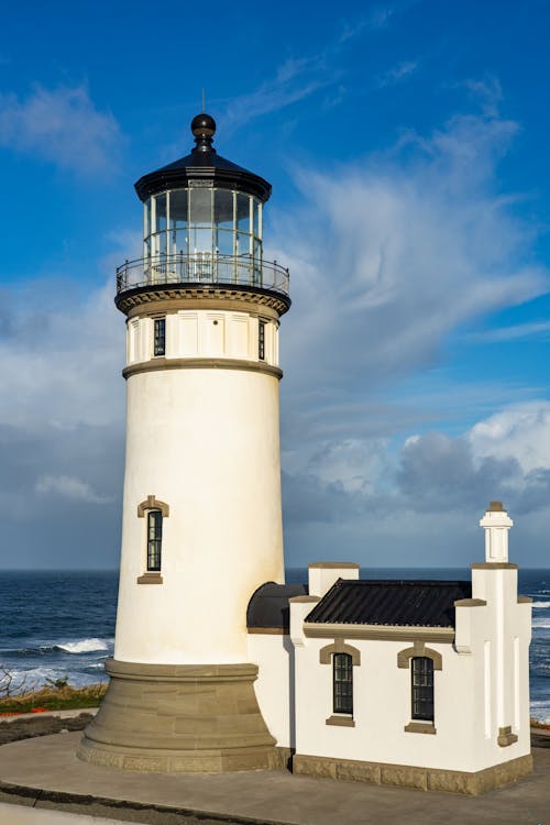 Cape Disappointment Lighthouse In Washington Under A Blue And Cloudy Sky