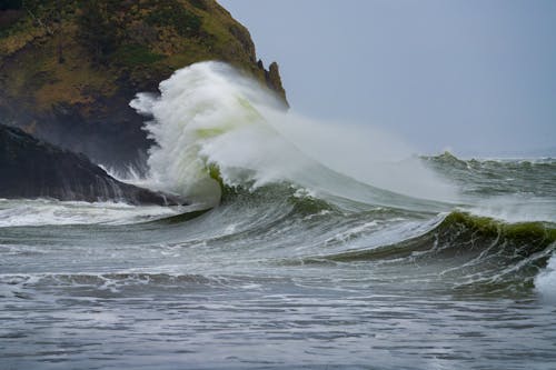Ocean Waves Crashing on Brown Rock Formation