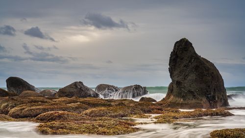 Free Captivating view of rugged rock formations with ocean waves at Clallam Bay, Washington. Stock Photo