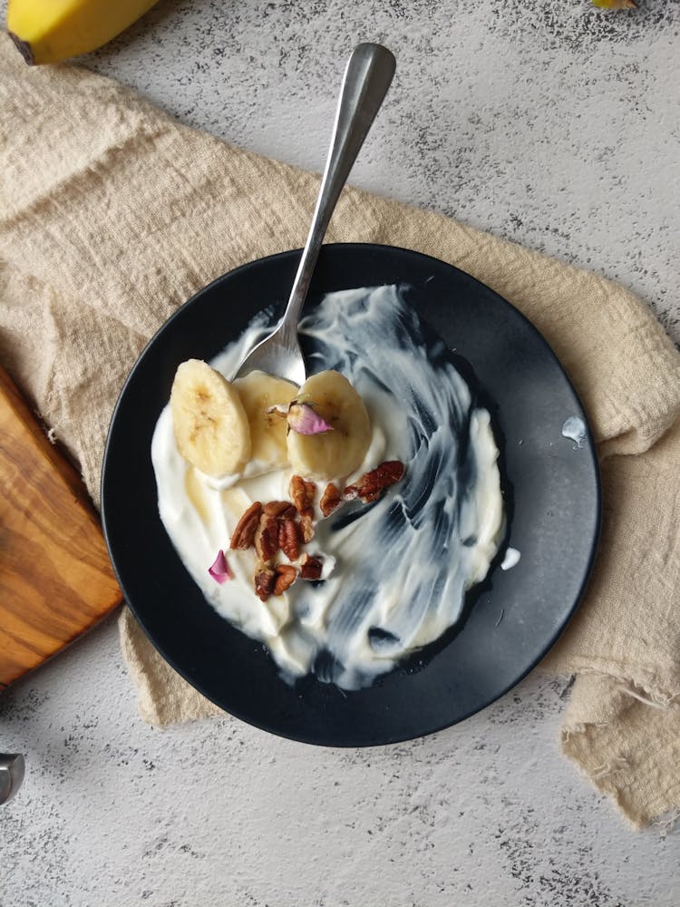 Yogurt With Banana Slices And Pecan Nuts