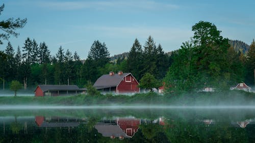 Fog Above Water and Among Huts in a Mountain Valley 