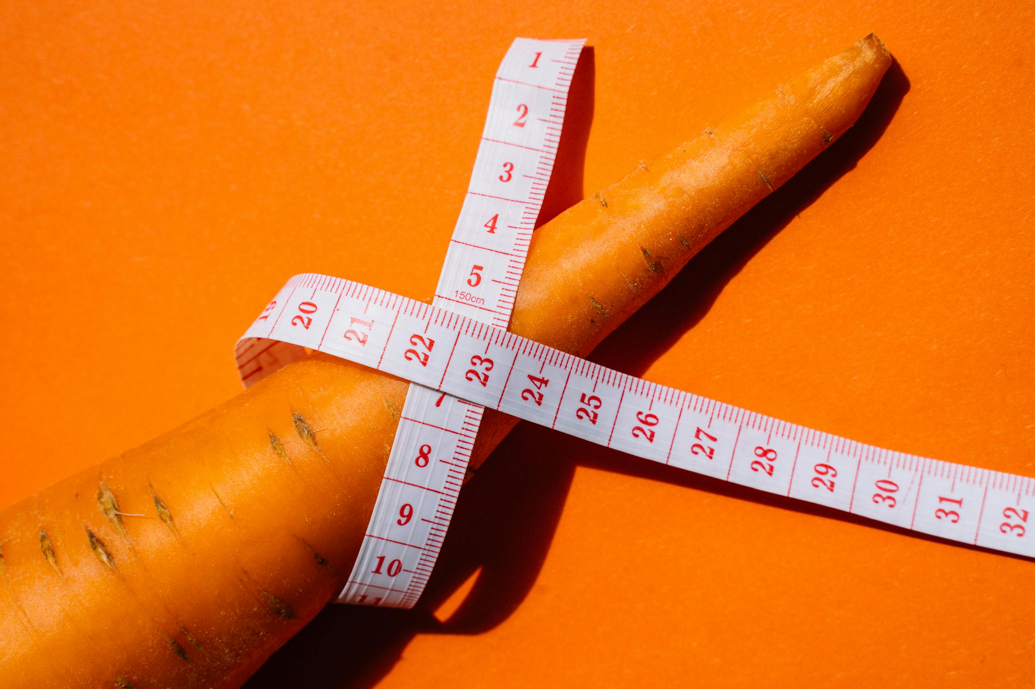 a carrot wrapped by a measuring tape