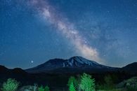 Green Trees Near Mountain Under Starry Night