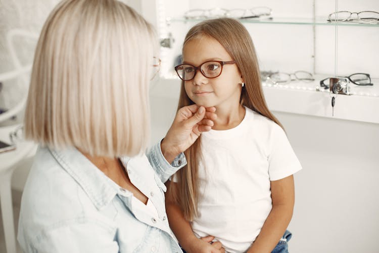 Small Girl Getting Glasses At Optician 