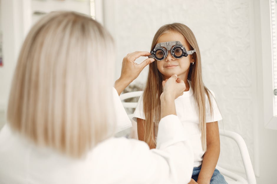 A young girl getting an eye exam at a healthcare clinic with optometrist assistance.