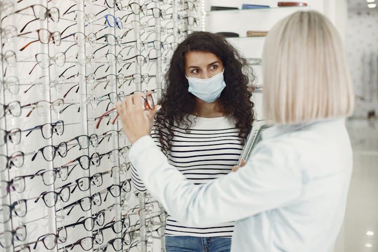 Women With Eyeglasses At Optician Store