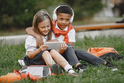 Schoolboy and Schoolgirl Using Tablet