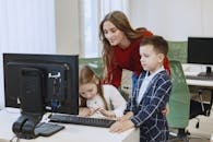 Teacher with Children Using Computer