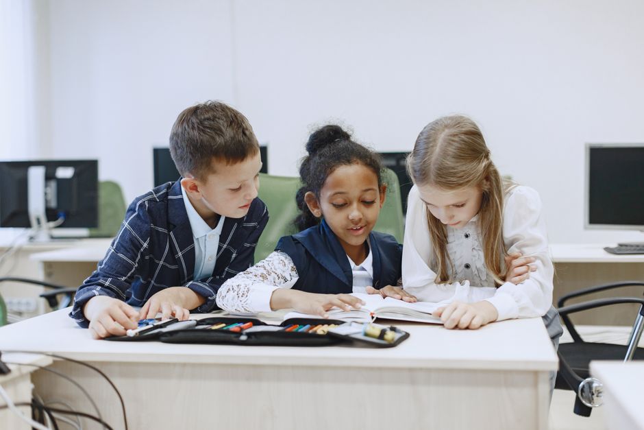 Children studying together happily in a small classroom setting Children studying together happily in a small classroom setting