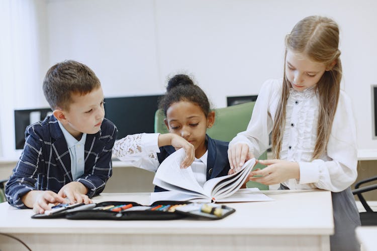 Girls Flipping The Pages Of The Book 