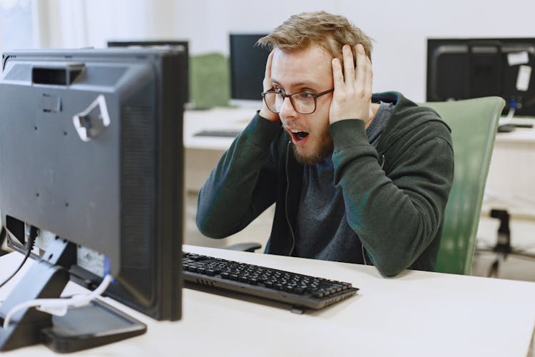 Shocked Man Looking At The Computer Monitor 