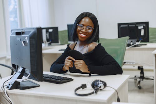 Woman in Black Long Sleeve Shirt Holding a Black Face Mask 