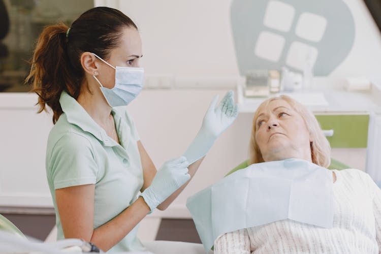 Elderly Woman Lying In A Dentist Room 