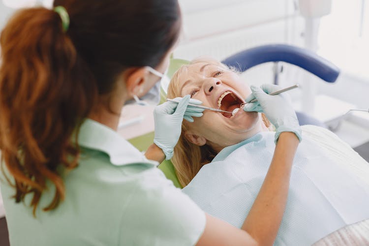 Dentist Working With Patient