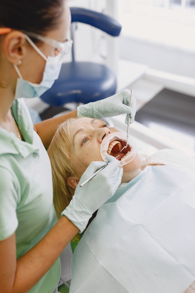 An Elderly Woman Lying Down With Her Mouth Open