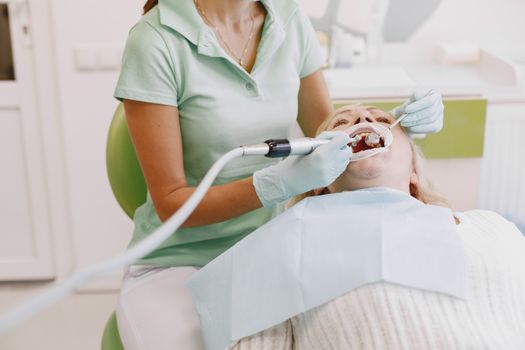 Dental hygienist performing a cleaning.