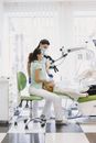 Woman in White Tank Top Sitting on Green and White Hospital Bed
