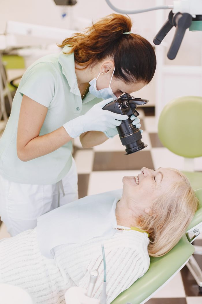 Dentist taking clinical photographs of a patient for dental planning