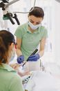 Dentist with Assistant and Patient in Office