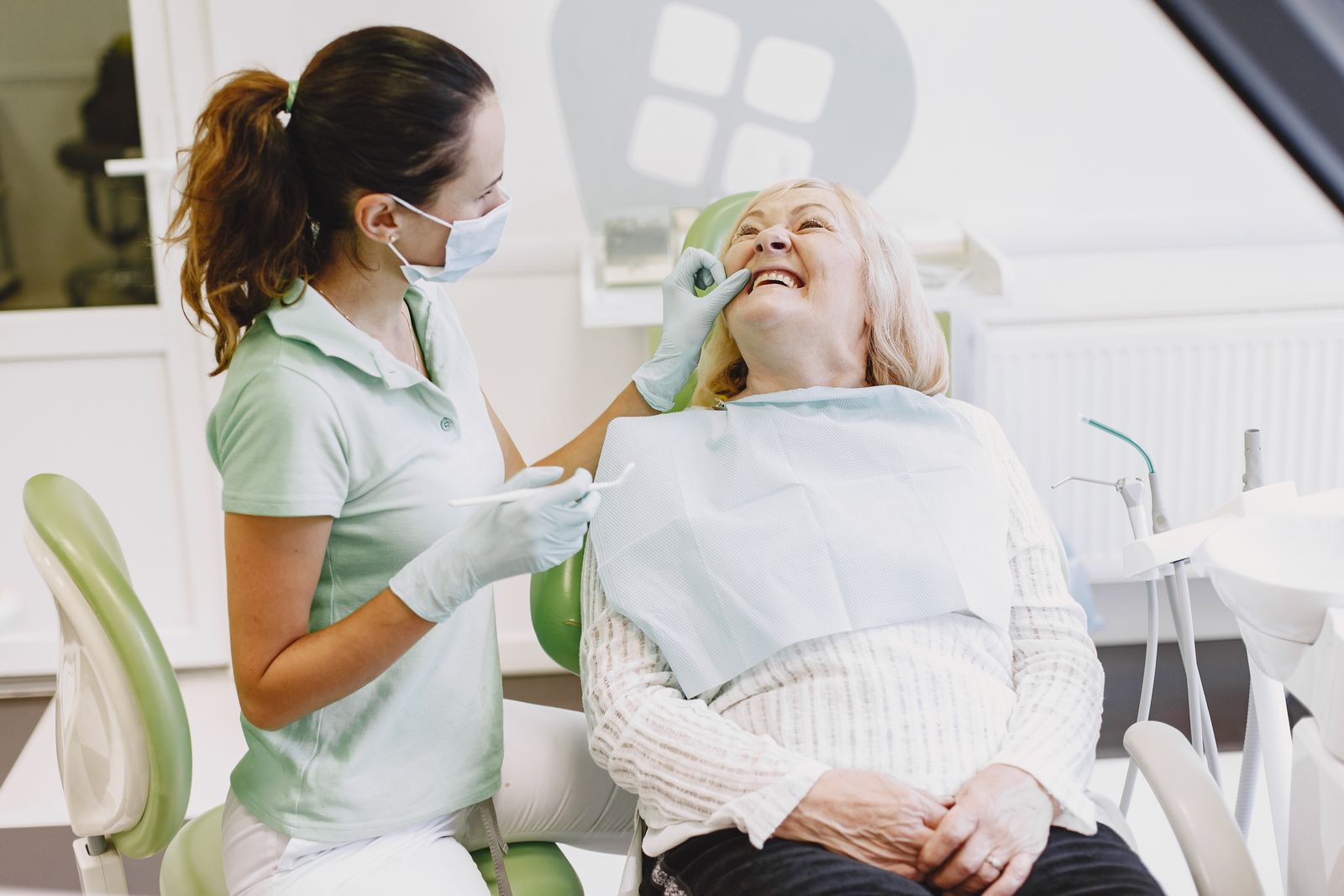 A hygienist with a smiling patient