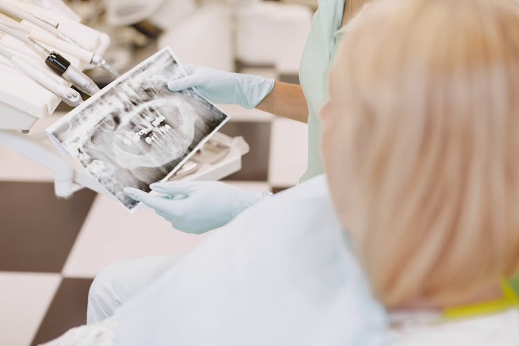 Dentist Showing Patient Teeth Xray