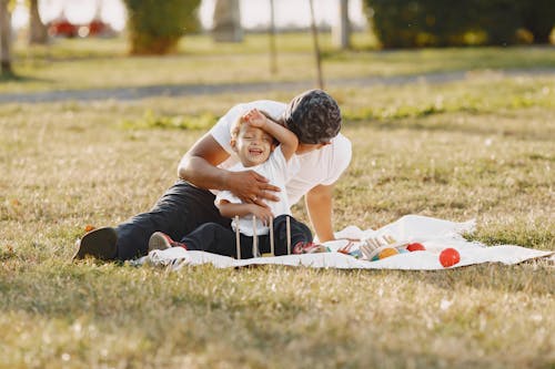 Man with Son on Grass