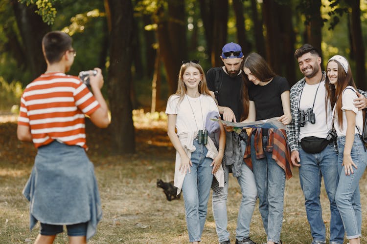 Group Of Friends With Map In Forest