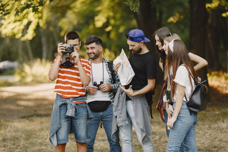 Group Of Hikers With Map And Camera