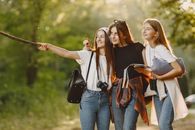 Happy Girlfriends Making Selfie in Forest