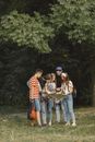 Man in Red and White Striped Long Sleeve Shirt Standing Beside Woman in Blue Denim Jeans