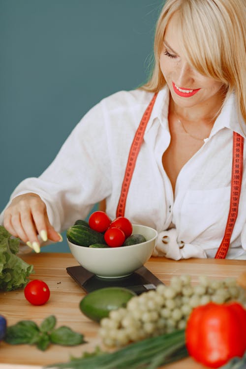 Free Woman Weighing Vegetables on Scales Stock Photo