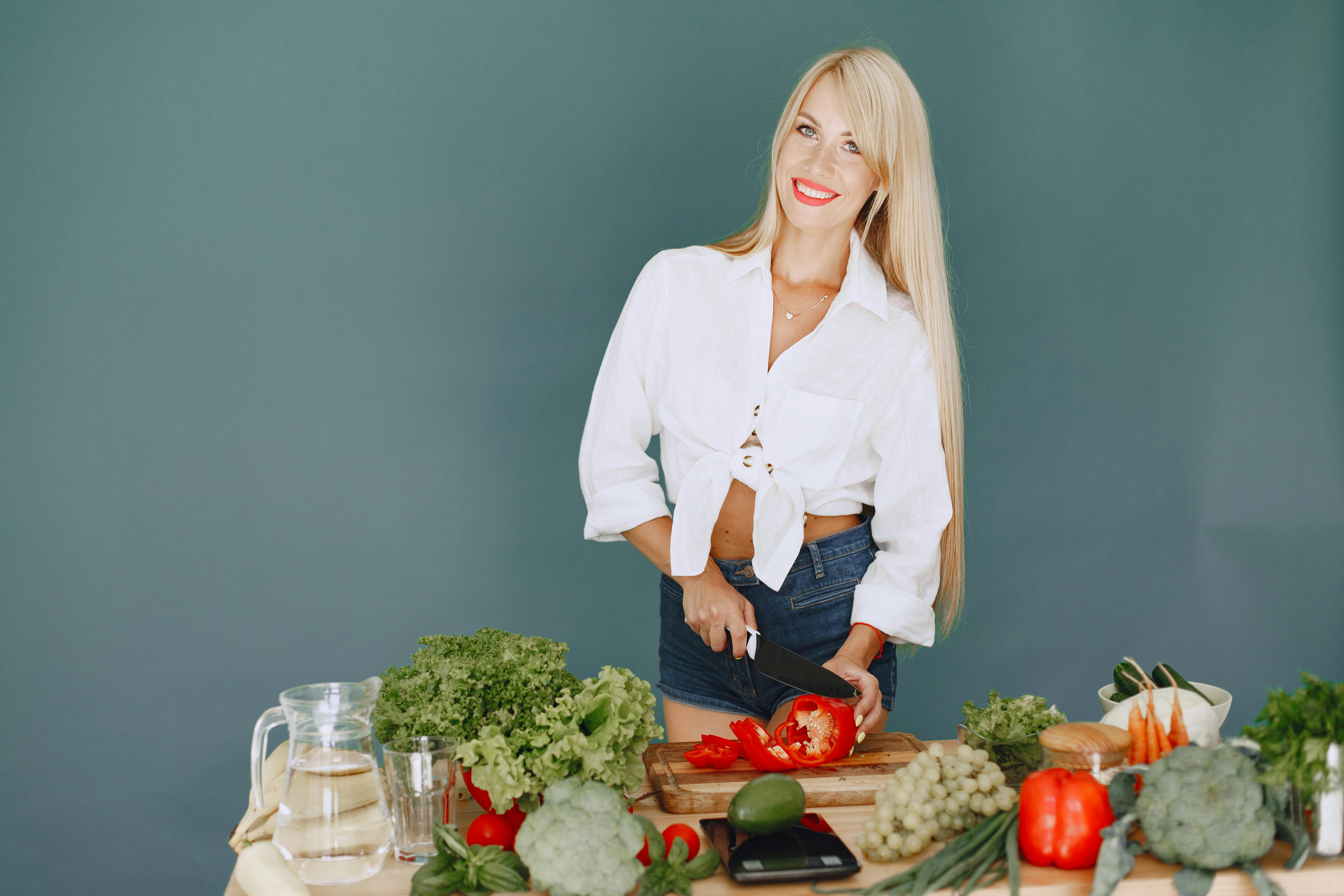 Woman chopping vegetables on a cutting board in a kitchen