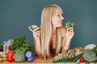 Blonde Woman Holding Green Plant