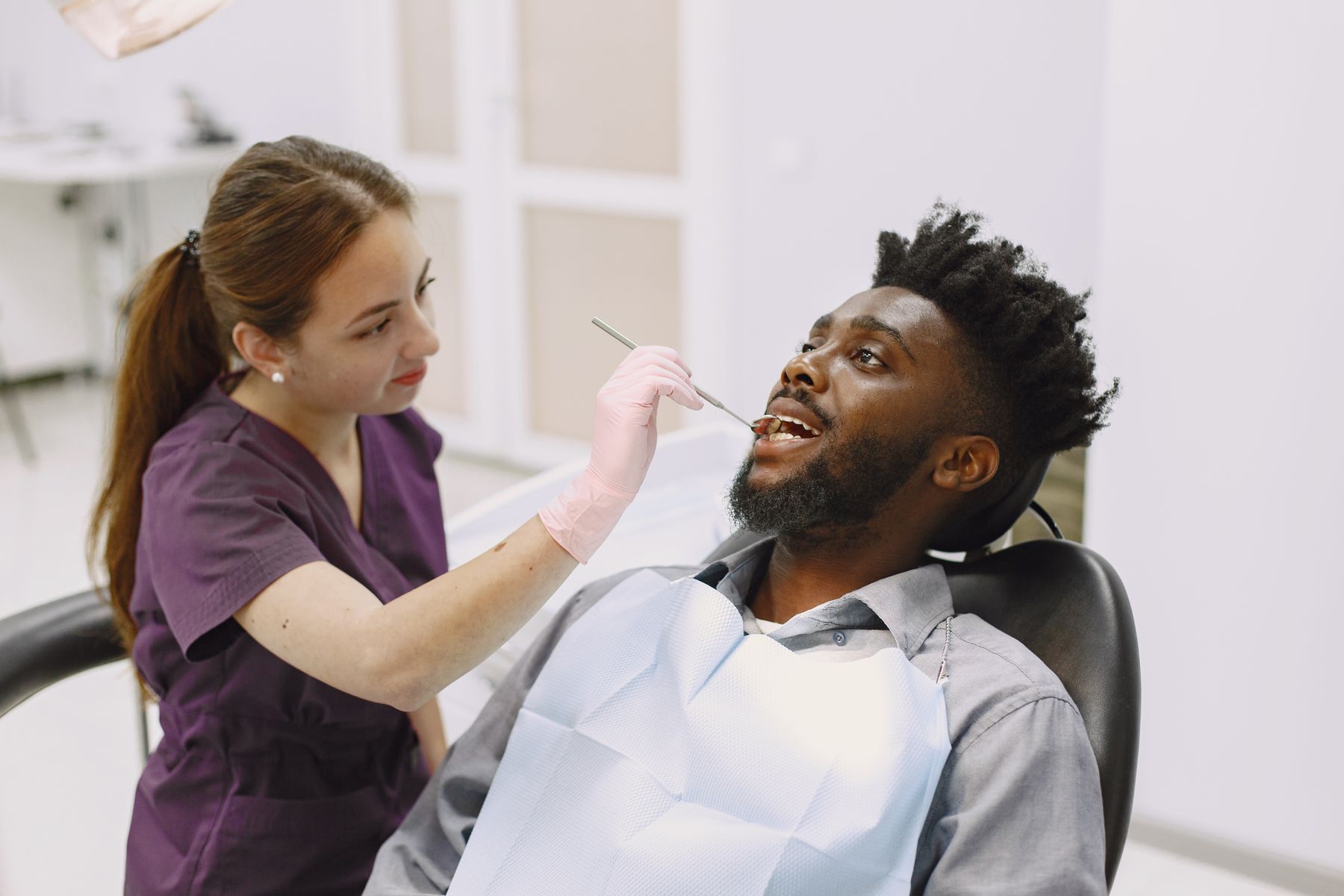 Smiling dental patient and clinician in a bright modern private dental clinic