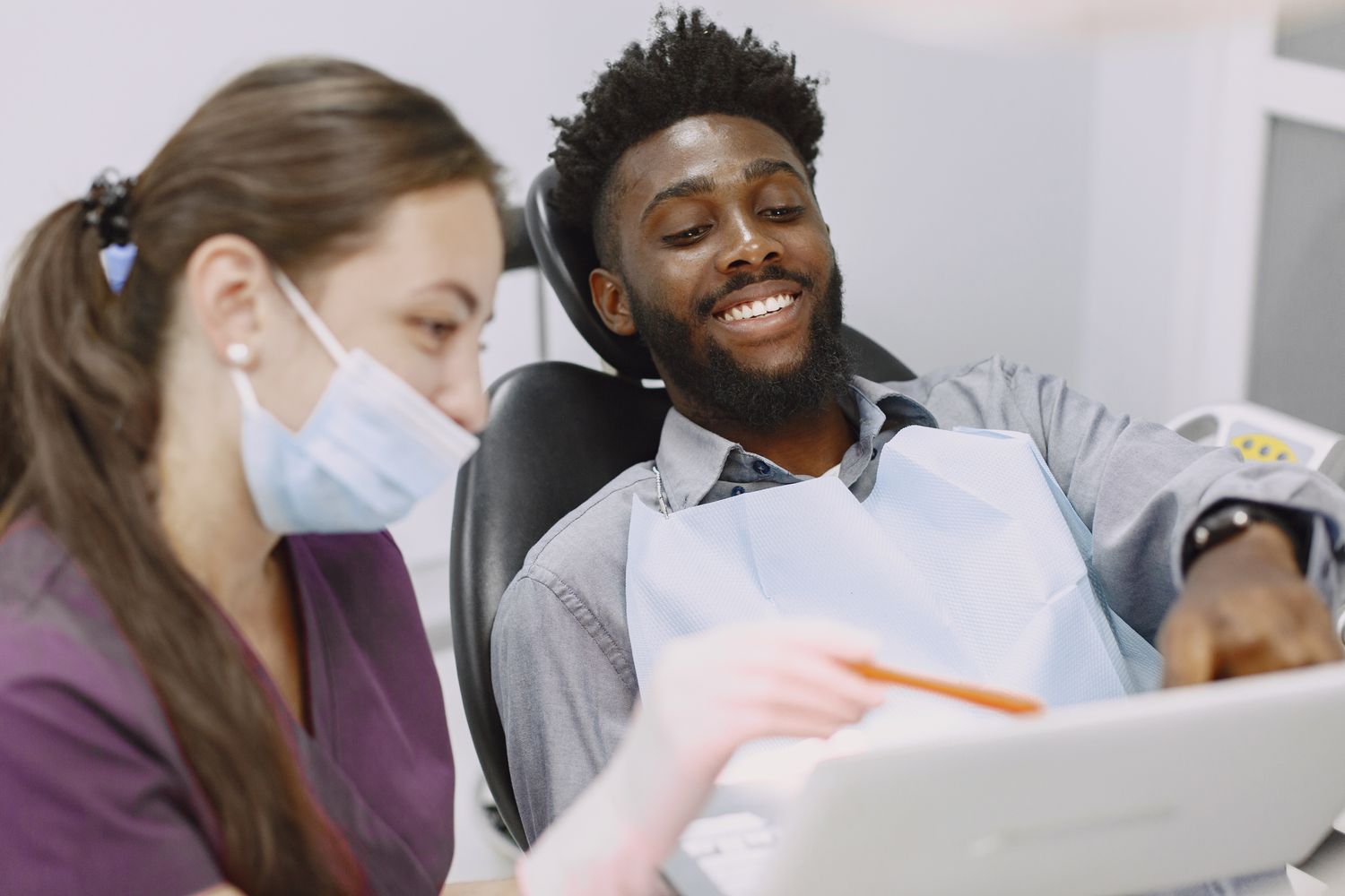 Dentist speaking with a satisfied patient