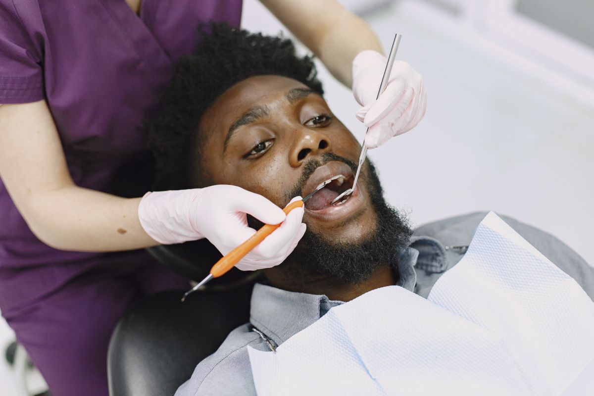 Dr. Wadie examines a patient's teeth during a routine checkup