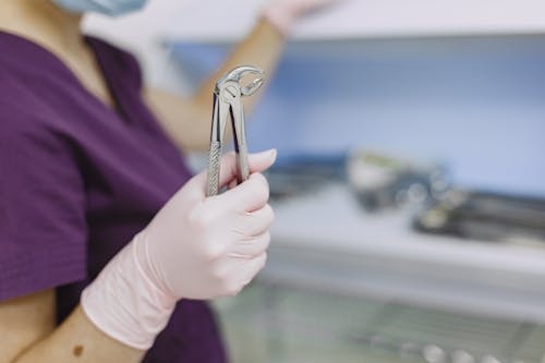 Free Shallow Focus Photo of Dentist Holding a Dental Forceps Stock Photo