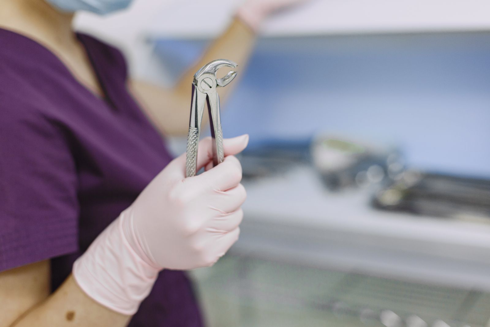 Dental extraction forceps in a professional dental setting