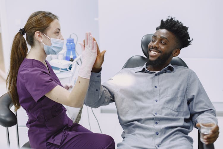 Dentist And Patient Doing High-Five