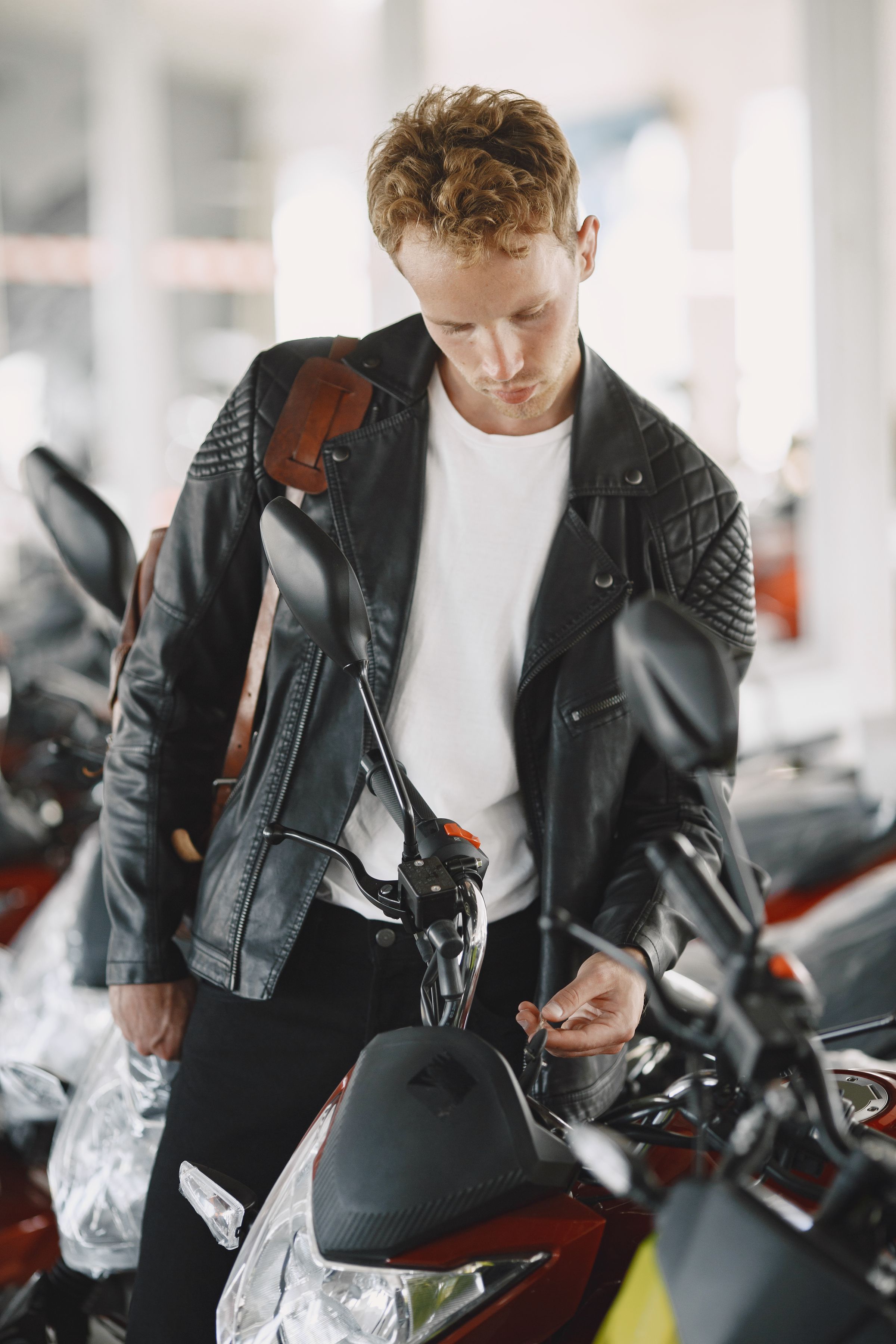 Black leather moto jacket, worn beside motorcycles