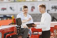 Man in White Dress Shirt Sitting on Red Chair