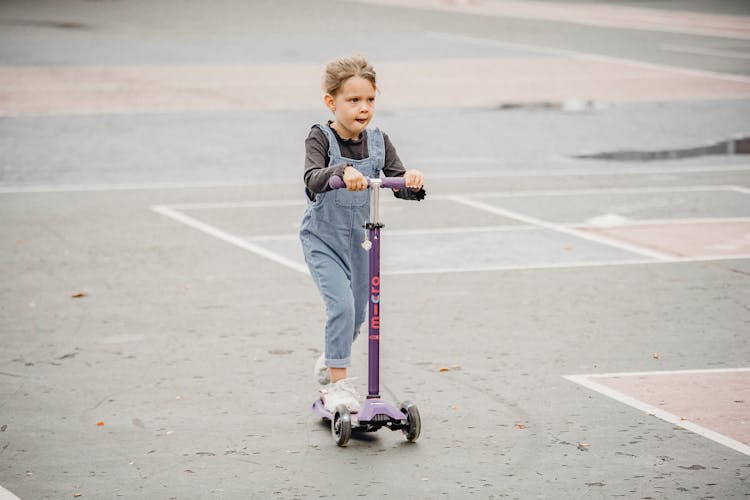 Cute Kid On Scooter In Sports Ground