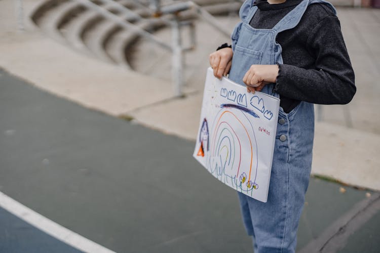 Crop Child With Drawing In Hands