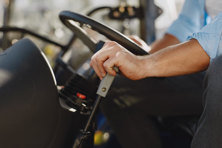 Close Up Of A Steering Wheel And Mans Hand On A Gear