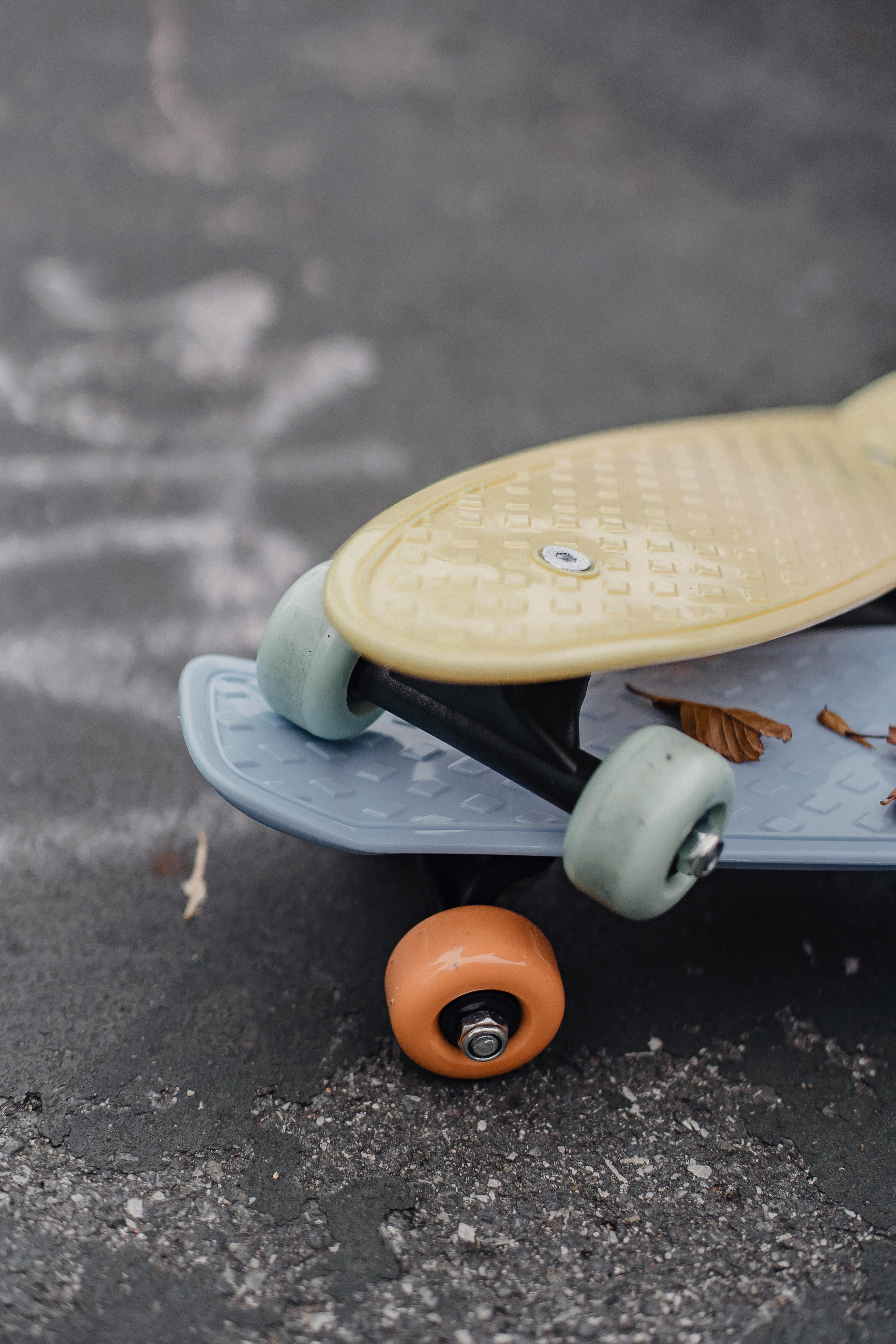 colorful skateboards on asphalt road