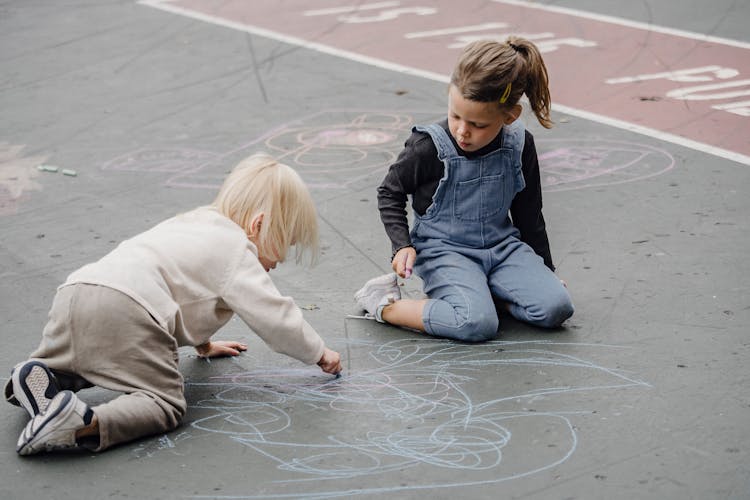 Adorable Girls Drawing On Asphalt