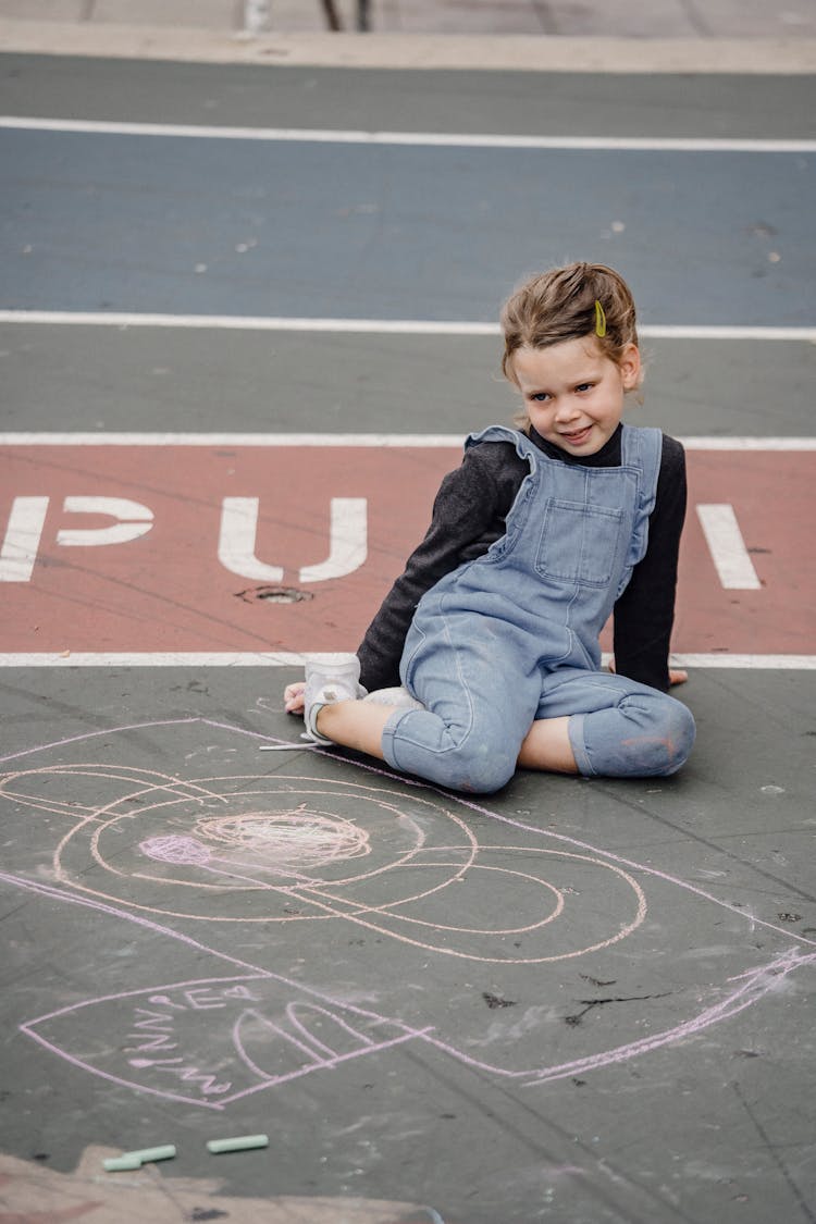 Cheerful Girl Sitting On Asphalt Neat Chalk Painting