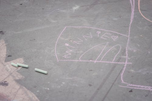 Free Pink chalk drawing on asphalt road Stock Photo